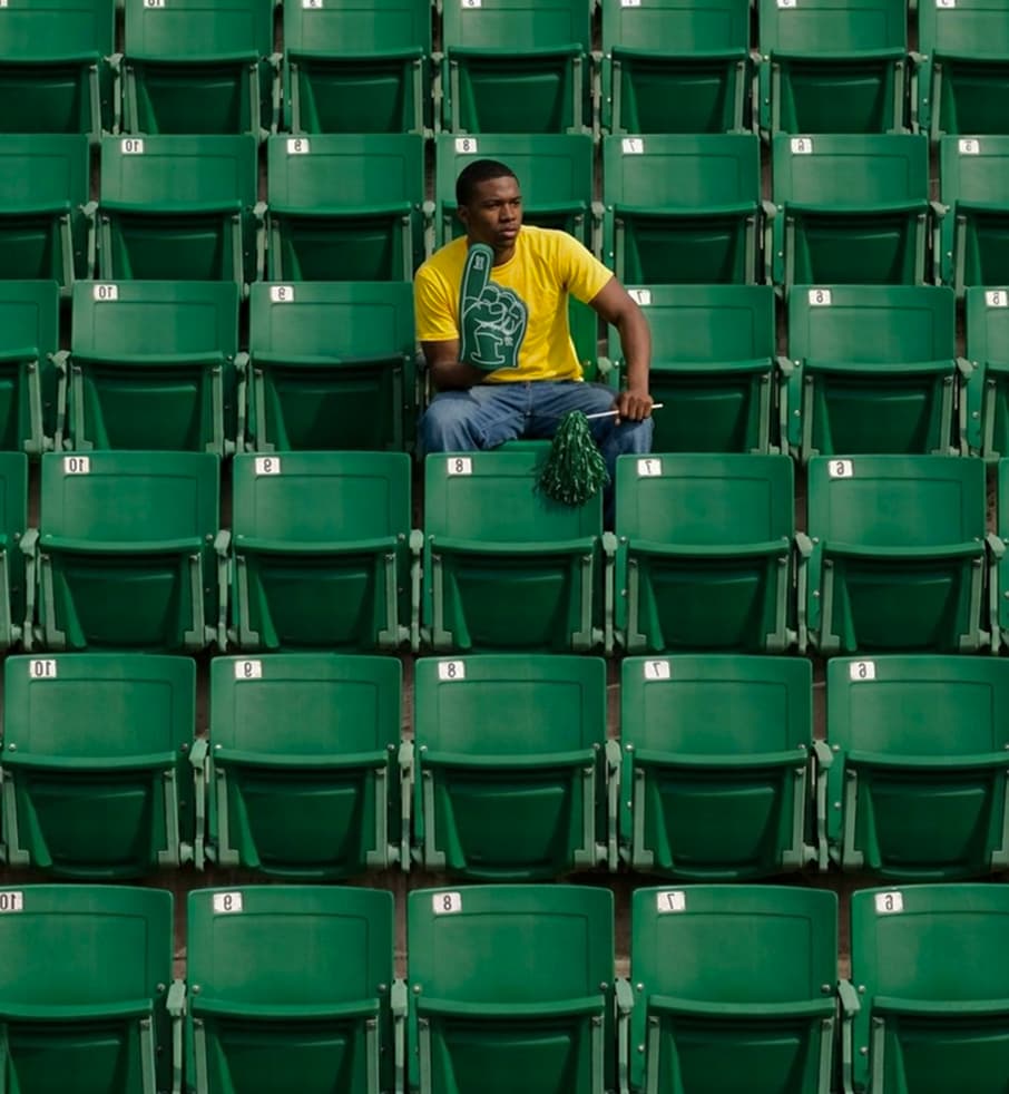 A lone fan sitting in an empty stadium — Nigeria is a Mirror
